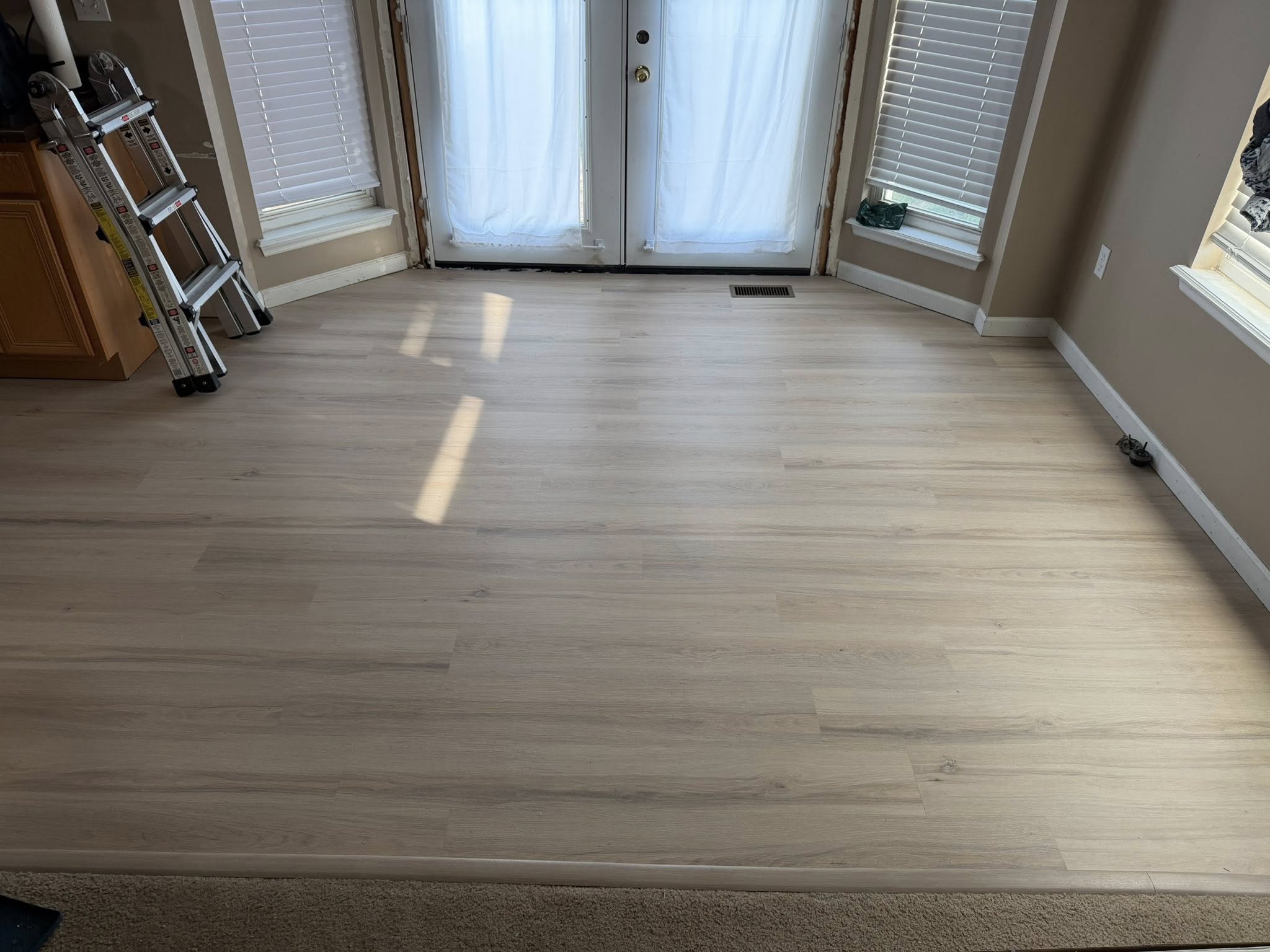 Deck with new steel French door, PVC trim, flashing, and insulation around the opening