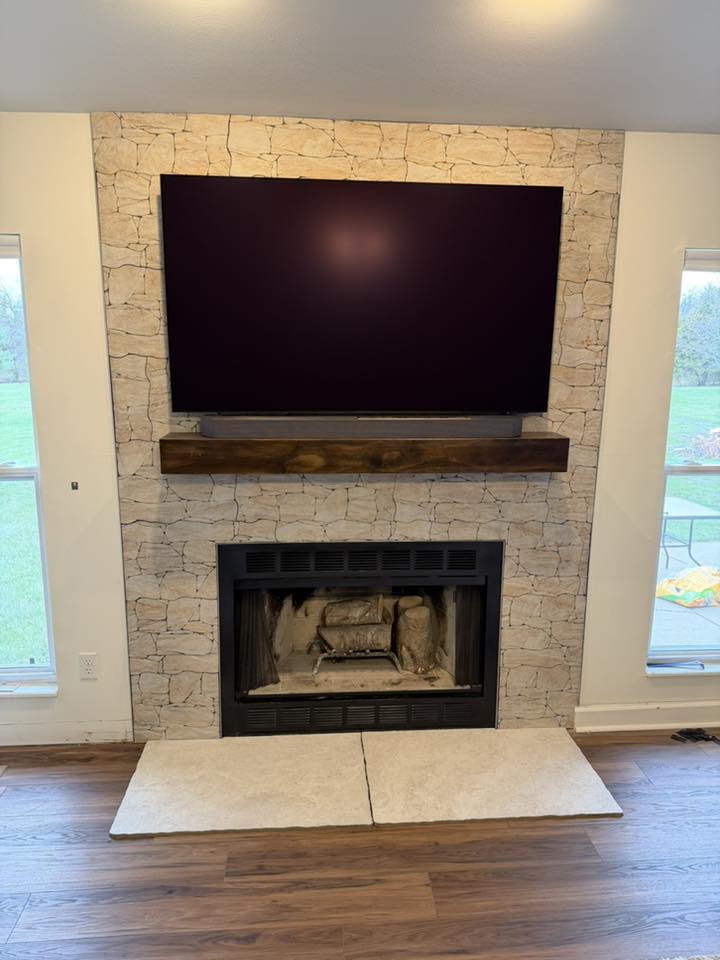 Custom stone mantel close-up, sized to support a large surround-sound bar